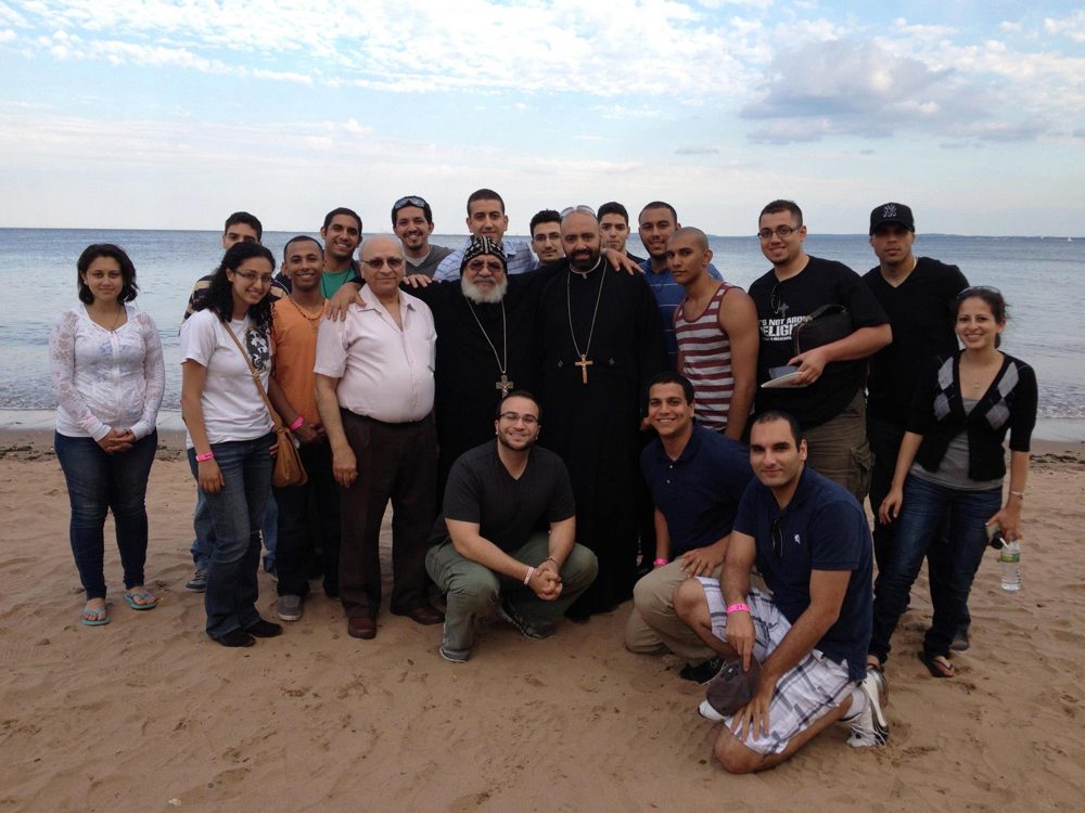 A group gathered for a photo on the beach at the Pulse Fellowship BBQ, June 2012.