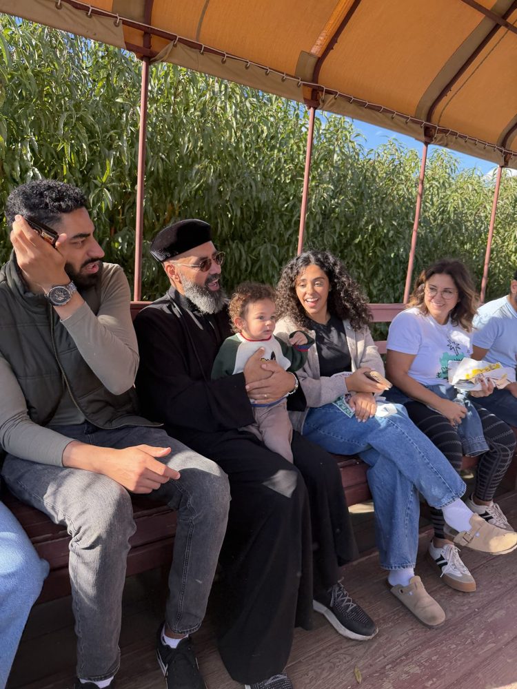 SPSA families and clergy sitting together on the hayride wagon at Silverman’s Farm.