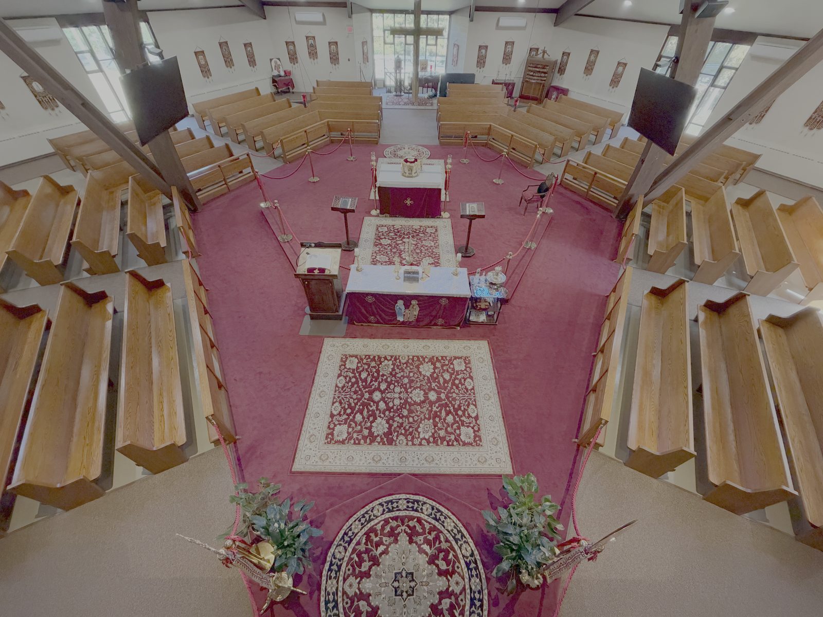 A view from the balcony looking down on the altar, the carpet and the pews of Saint Peter & Saint Andrew Church
